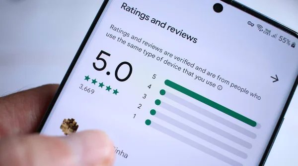 Customer checking a business's star ratings and reviews on a phone, a key Google Maps ranking signal